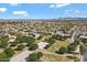 Aerial view of a residential community with green spaces and mature trees under a sunny sky at 19820 E Reins Rd, Queen Creek, AZ 85142