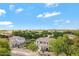 An aerial shot showcases the home and its neighborhood amidst lush greenery and clear blue skies at 19820 E Reins Rd, Queen Creek, AZ 85142