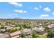 Sweeping aerial view of a suburban neighborhood, showcasing rooftops and desert landscaping at 19820 E Reins Rd, Queen Creek, AZ 85142
