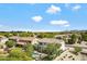 High-angle view of residences, displaying lush landscaping and a community swimming pool at 19820 E Reins Rd, Queen Creek, AZ 85142
