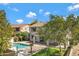 Inviting backyard showcases a pristine pool, manicured lawn, and cozy patio area at 19820 E Reins Rd, Queen Creek, AZ 85142
