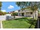 Manicured backyard with lush green grass, swimming pool, and covered patio perfect for outdoor entertaining at 19820 E Reins Rd, Queen Creek, AZ 85142