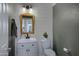 Charming bathroom with white shiplap walls, modern vanity, and rustic mirror, blending style with functionality at 19820 E Reins Rd, Queen Creek, AZ 85142