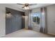 Cozy bedroom featuring a barn door accent wall, carpeted floors, and a bright window for natural light and warmth at 19820 E Reins Rd, Queen Creek, AZ 85142