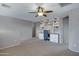 Versatile bonus room featuring a built-in desk area, carpeted flooring, and ample lighting for productivity at 19820 E Reins Rd, Queen Creek, AZ 85142