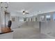 Spacious bonus room with natural light, carpeted floors, and a ceiling fan, perfect for versatile use at 19820 E Reins Rd, Queen Creek, AZ 85142
