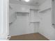 Bright, white walk-in closet featuring ample shelving and storage space at 19820 E Reins Rd, Queen Creek, AZ 85142