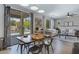 Dining area with a table set, leading to a pool and cozy living room at 19820 E Reins Rd, Queen Creek, AZ 85142