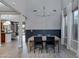 Open dining room with high ceilings, modern light fixture, and view into living spaces at 19820 E Reins Rd, Queen Creek, AZ 85142