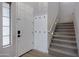Welcoming entryway featuring a staircase with carpeted steps, a coat rack, and stylish lighting for a modern touch at 19820 E Reins Rd, Queen Creek, AZ 85142
