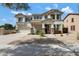 Charming two-story stucco home featuring a well-manicured yard and attached two-car garage at 19820 E Reins Rd, Queen Creek, AZ 85142