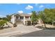 Attractive two-story home featuring a neutral color scheme, landscaped yard, and a three-car garage at 19820 E Reins Rd, Queen Creek, AZ 85142