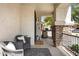 Charming front porch featuring seating, stone columns, and an inviting entrance at 19820 E Reins Rd, Queen Creek, AZ 85142