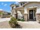 Close up of an inviting front porch with stone pillars and a charming decorative wreath on the door at 19820 E Reins Rd, Queen Creek, AZ 85142