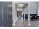 A stylish foyer featuring hardwood floors, elegant lighting fixtures and a dining area at 19820 E Reins Rd, Queen Creek, AZ 85142