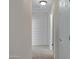 Well-lit hallway with neutral walls and carpeted floor, leading to various rooms, with white trim and doors at 19820 E Reins Rd, Queen Creek, AZ 85142
