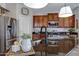 Well-lit kitchen with granite counters, stainless appliances, and dark wood cabinetry at 19820 E Reins Rd, Queen Creek, AZ 85142