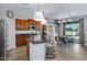 Open concept kitchen with a granite island, stainless appliances, and a dining area at 19820 E Reins Rd, Queen Creek, AZ 85142