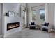 Bright living room featuring a modern fireplace and large windows with natural light at 19820 E Reins Rd, Queen Creek, AZ 85142