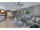 Open-concept living space featuring a living room that connects to dining area, with hardwood floors and ample natural light at 19820 E Reins Rd, Queen Creek, AZ 85142
