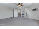 An airy main bedroom showcases dual entryways and a ceiling fan at 19820 E Reins Rd, Queen Creek, AZ 85142
