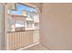 A view from the balcony to a neighboring building, showing the privacy screen and architectural details at 2049 N 77Th Dr, Phoenix, AZ 85035