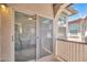View from the balcony to the dining room with ceiling fan visible through the sliding glass door at 2049 N 77Th Dr, Phoenix, AZ 85035