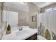 Bathroom features a white vanity, mirror, cactus shower curtain, and a decorative bird at 2049 N 77Th Dr, Phoenix, AZ 85035