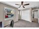 Bedroom with a ceiling fan, closet, and a view of the neighborhood from the window at 2049 N 77Th Dr, Phoenix, AZ 85035