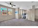Upstairs bedroom with a ceiling fan and a cozy workspace at 2049 N 77Th Dr, Phoenix, AZ 85035