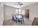 Bright dining area featuring a sleek table and chairs, carpet flooring, and sliding glass door to a patio at 2049 N 77Th Dr, Phoenix, AZ 85035
