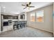 Bright and airy living space with a ceiling fan, carpet flooring, and a view of the neighborhood at 2049 N 77Th Dr, Phoenix, AZ 85035