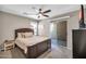 Comfortable main bedroom with a dark wood bed frame and access to a private balcony at 2049 N 77Th Dr, Phoenix, AZ 85035