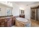 Spacious bathroom with a large tub, dual vanities, and a glass-enclosed shower at 21817 N 39Th St, Phoenix, AZ 85050