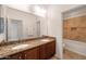 Bathroom featuring double sinks with granite countertops and a tiled shower/tub at 21817 N 39Th St, Phoenix, AZ 85050