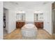 Bright bathroom featuring dual sinks with granite countertops and a tiled soaking tub at 21817 N 39Th St, Phoenix, AZ 85050