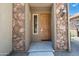 Charming home exterior with a stone facade and a well-lit entry leading to the front door at 21817 N 39Th St, Phoenix, AZ 85050