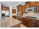 Modern kitchen with stainless steel appliances, granite countertops, and abundant storage at 21817 N 39Th St, Phoenix, AZ 85050