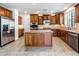 Lovely kitchen features a large island, granite counters, tiled floors, and stainless appliances at 21817 N 39Th St, Phoenix, AZ 85050