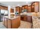 This kitchen features a center island with granite, stainless appliances, and ample cabinet space at 21817 N 39Th St, Phoenix, AZ 85050