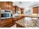 Elegant kitchen showcases granite countertops, custom cabinets, and a suite of modern appliances at 21817 N 39Th St, Phoenix, AZ 85050