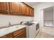Well-equipped laundry room with ample cabinet storage and modern washer and dryer units at 21817 N 39Th St, Phoenix, AZ 85050