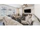 Cozy living room showcasing an oversized sectional couch, a large window, and a mounted television at 21817 N 39Th St, Phoenix, AZ 85050