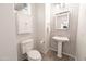 Elegant powder room with stylish mosaic tile, pedestal sink, and a sleek, modern design at 21817 N 39Th St, Phoenix, AZ 85050