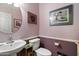 Powder room with a pedestal sink, artwork, and toilet at 26408 N 53Rd Gln, Phoenix, AZ 85083