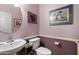 This bathroom includes a sink, mirror, toilet, wainscotting and decor at 26408 N 53Rd Gln, Phoenix, AZ 85083