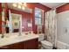 A bathroom with a single sink vanity, shower/tub, and floral shower curtain at 26408 N 53Rd Gln, Phoenix, AZ 85083