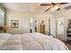 Bright bedroom featuring a large bed, ceiling fan, and access to closet and bathroom at 26408 N 53Rd Gln, Phoenix, AZ 85083
