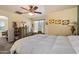 Well-lit bedroom with a ceiling fan, artwork and a comfortable looking bed at 26408 N 53Rd Gln, Phoenix, AZ 85083