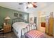 A cozy bedroom with sage green walls, ceiling fan, and neutral-toned carpet at 26408 N 53Rd Gln, Phoenix, AZ 85083